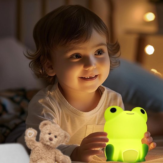 Petite fille qui profite d'un moment de douceur avec sa veilleuse grenouille