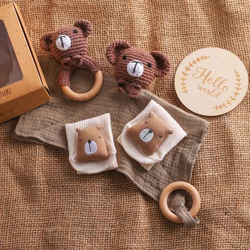 Ambiance chambre bébé douce avec coffret naissance premium posé sur surface en bois naturel